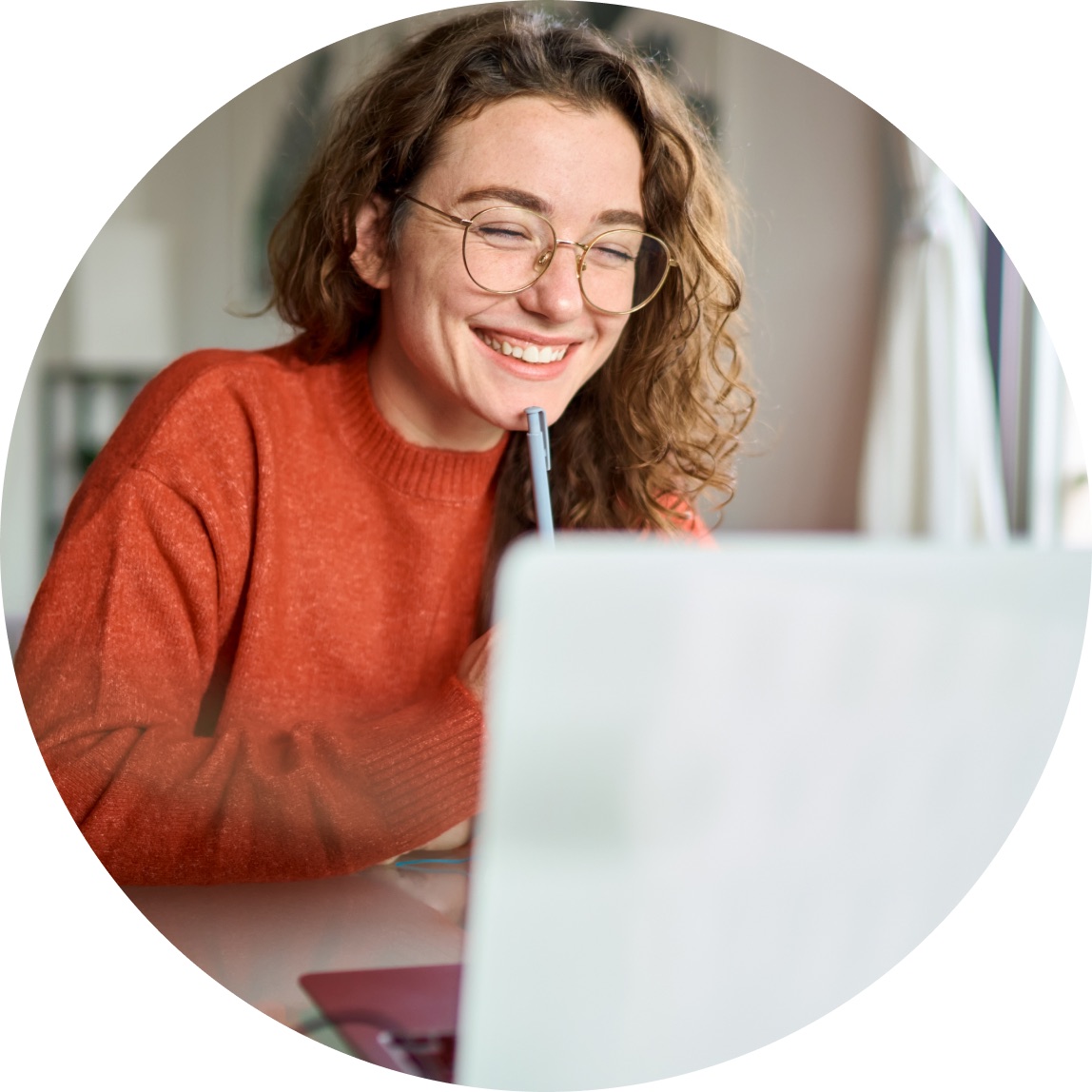 Smiling woman working through CPD training on her laptop